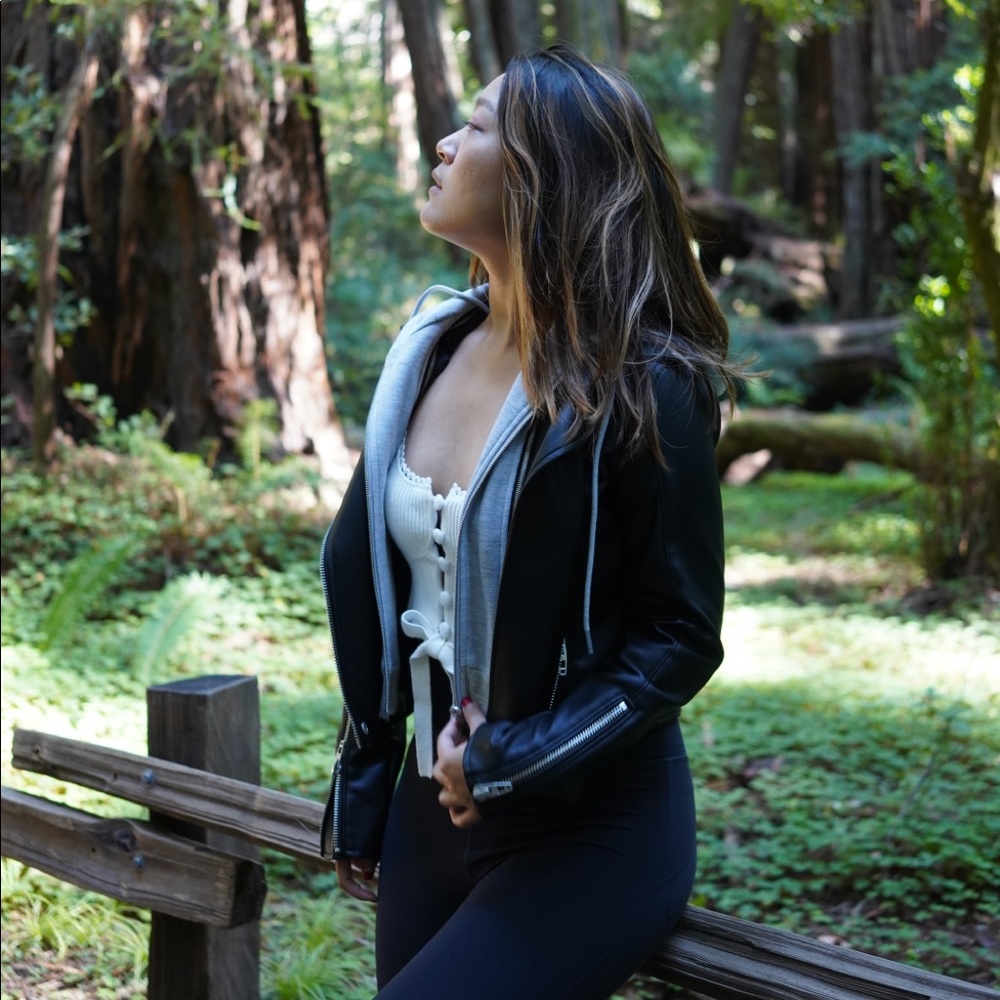 Leather jacket with grey hoodie attached